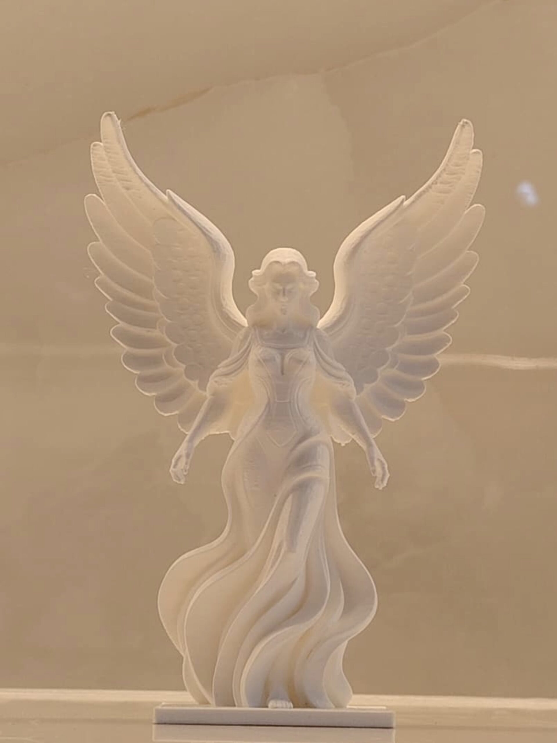 white angel sculpture||flowing gown design with spread wings